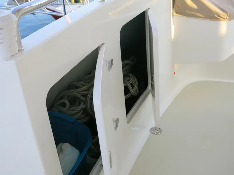 Slide: The Image of Open storage compartment on 2017 Kadey-Krogen 58EB boat deck with ropes and container. - 60
