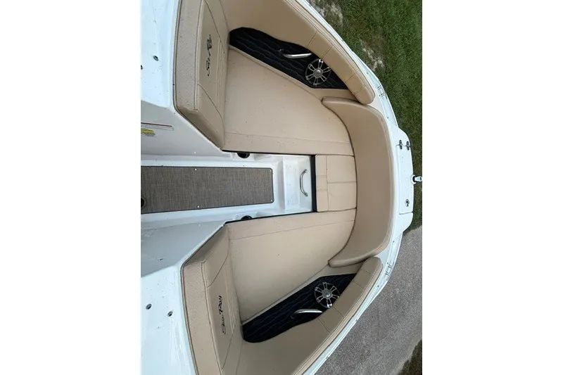 Slide: The Image of 2023 Sea Ray SPX 210 boat interior with beige seating and sleek design. - 7