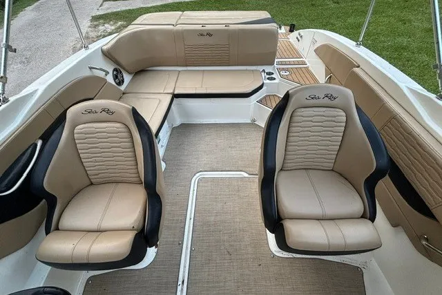Slide: The Image of 2023 Sea Ray SPX 210 boat interior with beige seating and modern design. - 6