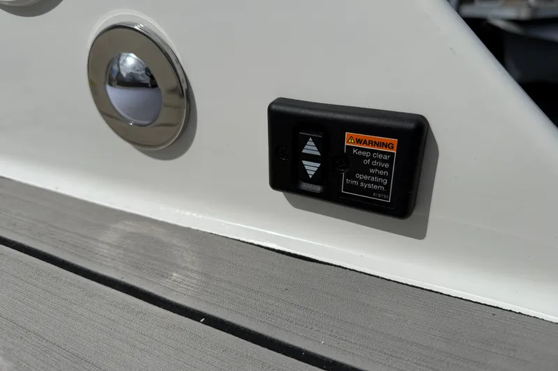 Slide: The Image of 2026 Sea Ray SDX 230 boat detail with warning label and metal fixture. - 13
