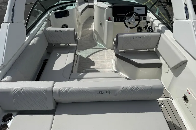 Slide: The Image of 2026 Sea Ray SDX 230 boat interior with luxurious seating and modern dashboard. - 11