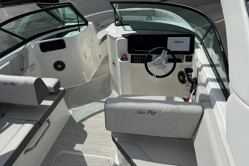 Slide: The Image of 2026 Sea Ray SDX 230 boat interior with modern dashboard and comfortable seating. - 6