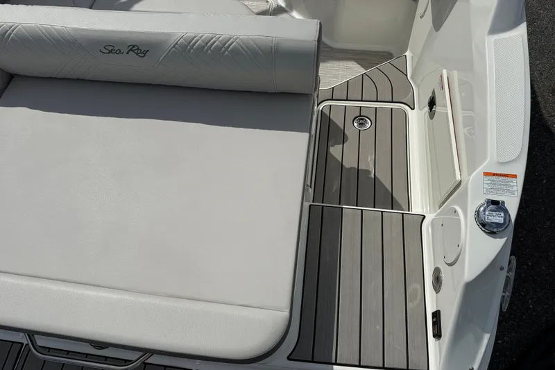 Slide: The Image of 2026 Sea Ray SDX 230 boat interior with cushioned seating and sleek deck design. - 12