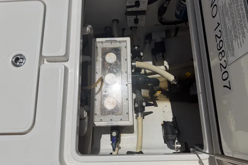 Slide: The Image of 2019 Invincible 36 Open Fisherman boat's baitwell system with visible hoses and controls. - 37