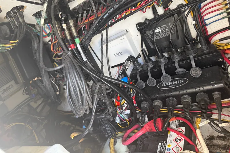 Slide: The Image of Electrical wiring and Garmin equipment inside a 2019 Invincible 36 Open Fisherman boat. - 48