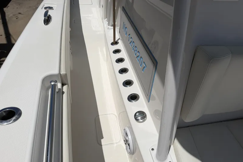 Slide: The Image of 2019 Invincible 36 Open Fisherman boat interior with rod holders and seating. - 32