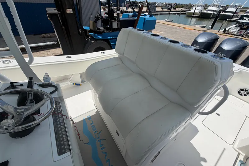 Slide: The Image of 2019 Invincible 36 Open Fisherman boat interior with white seating and steering wheel. - 16
