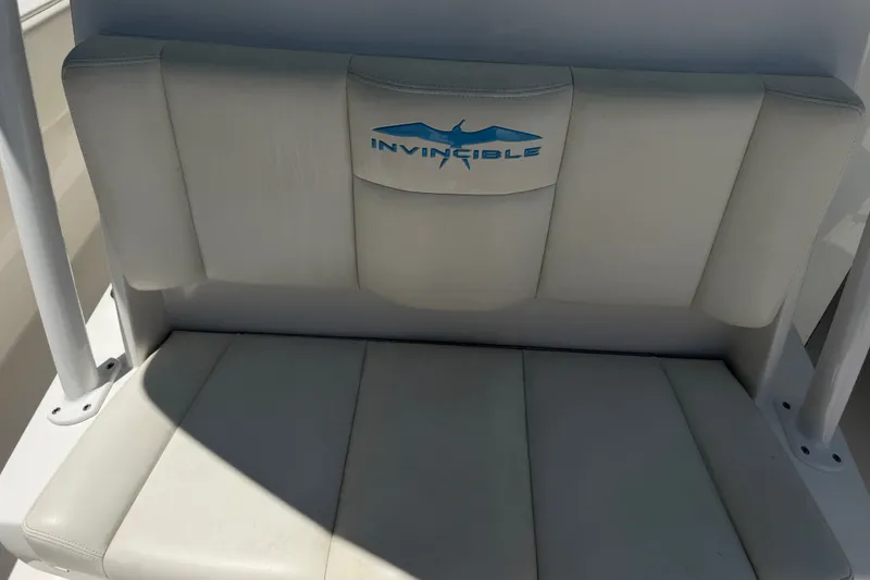 Slide: The Image of 2019 Invincible 36 Open Fisherman boat seat with logo, featuring white upholstery. - 33