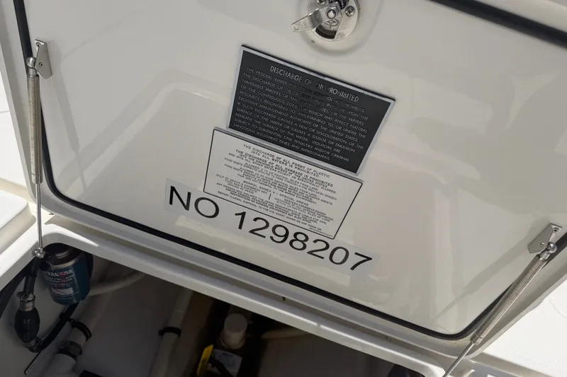 Slide: The Image of 2019 Invincible 36 Open Fisherman boat compartment with discharge warning label. - 42