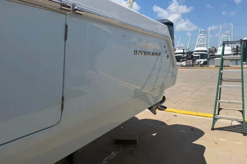 Slide: The Image of 2019 Invincible 36 Open Fisherman boat docked at marina under clear blue sky. - 4