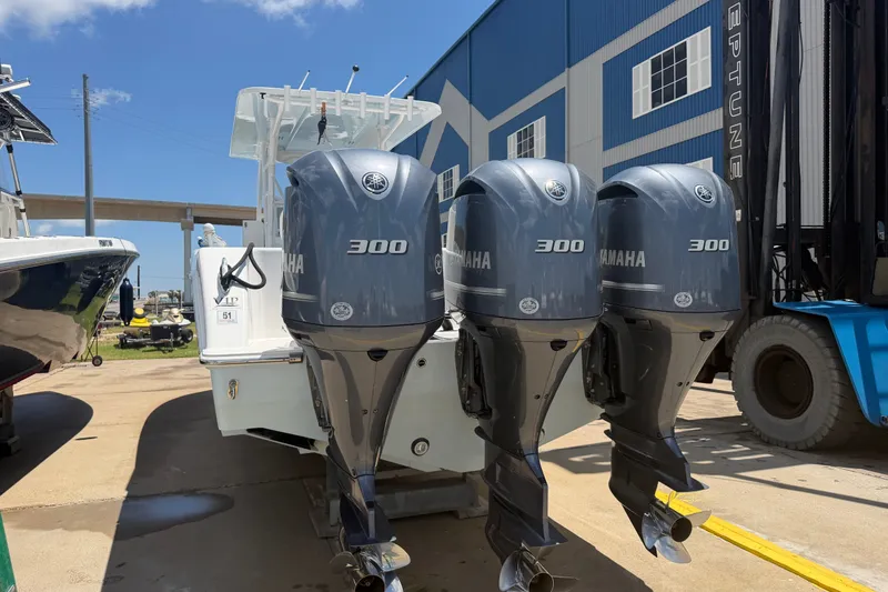 Slide: The Image of 2019 Invincible 36 Open Fisherman with triple Yamaha 300 engines at dockside. - 9
