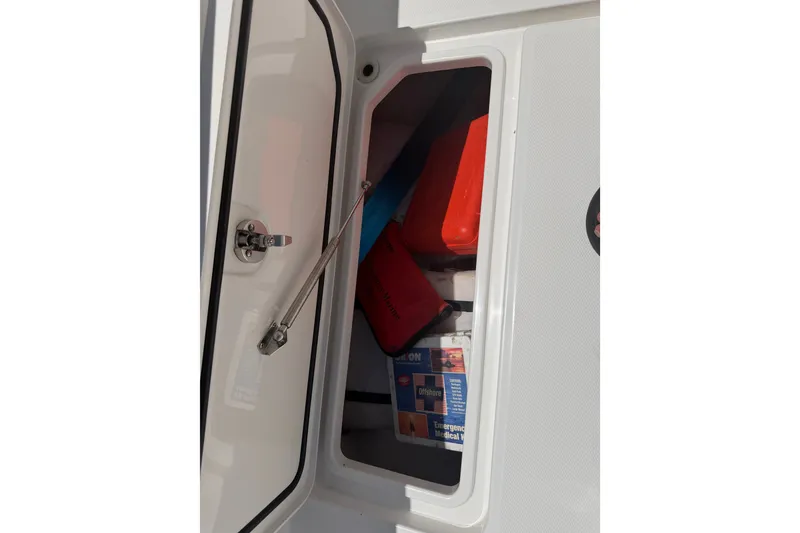 Slide: The Image of Storage compartment on a 2019 Invincible 36 Open Fisherman boat, containing emergency supplies. - 28
