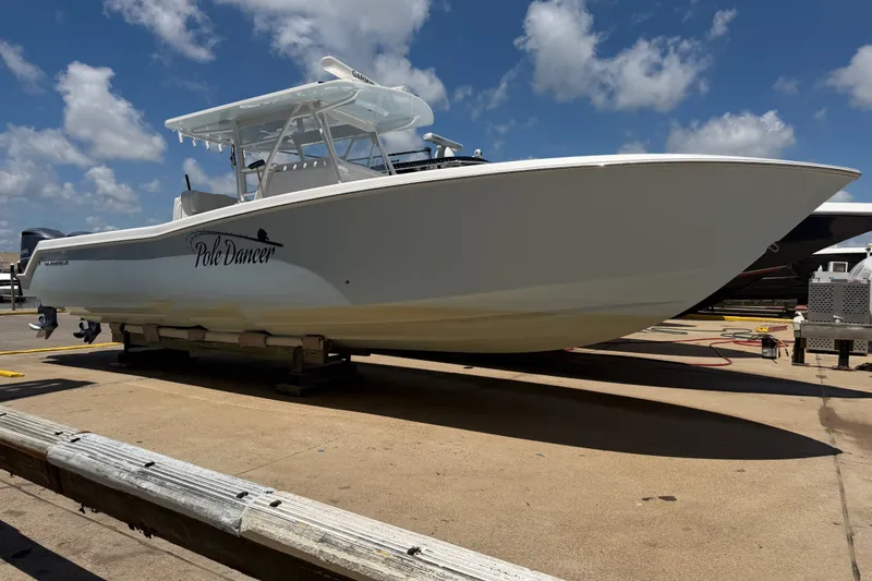 Slide: The Image of 2019 Invincible 36 Open Fisherman boat on dock under blue sky. - 1