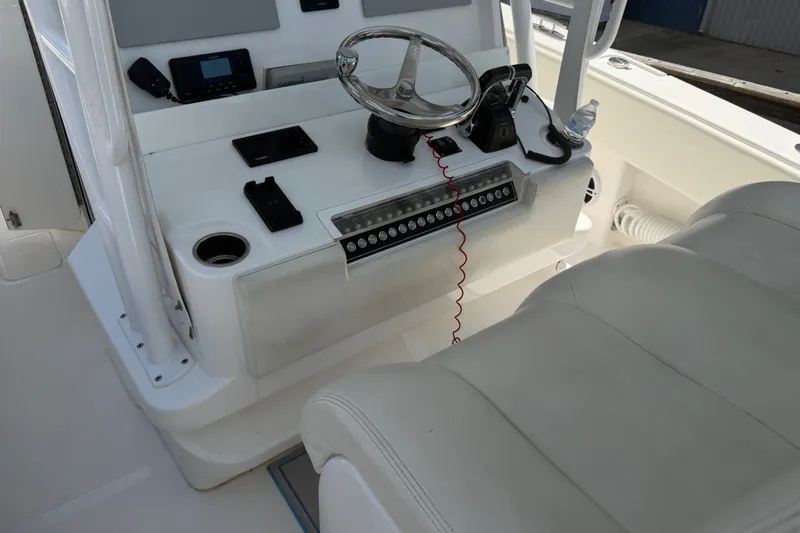 Slide: The Image of 2019 Invincible 36 Open Fisherman boat console with steering wheel and controls. - 17