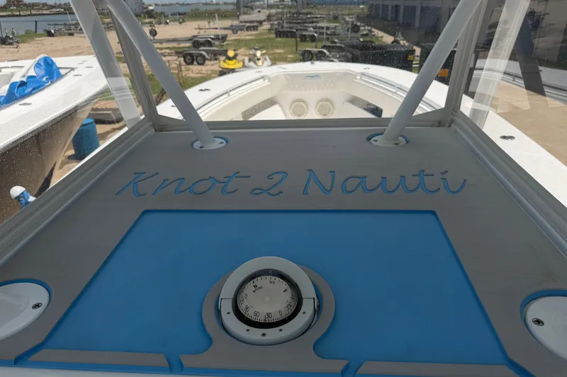 Slide: The Image of 2019 Invincible 36 Open Fisherman boat with "Knot 2 Nauti" inscription and compass. - 36