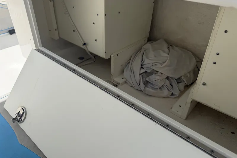 Slide: The Image of Open storage compartment on 2019 Invincible 36 Open Fisherman boat with folded fabric inside. - 60