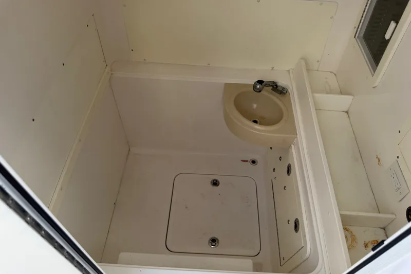 Slide: The Image of Interior of 2019 Invincible 36 Open Fisherman boat, featuring a compact sink area. - 21