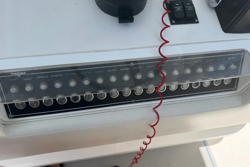 Slide: The Image of Control panel of a 2019 Invincible 36 Open Fisherman boat with labeled switches. - 55