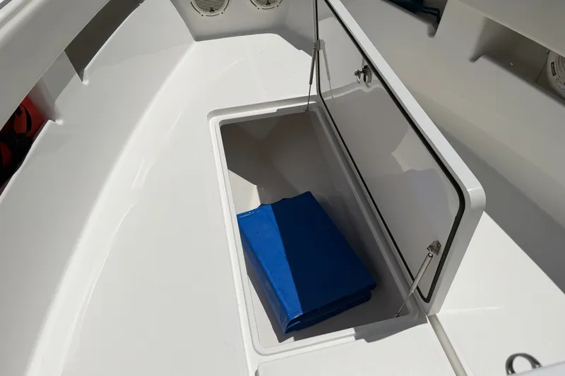 Slide: The Image of Storage compartment on 2019 Invincible 36 Open Fisherman boat with blue cover inside. - 25