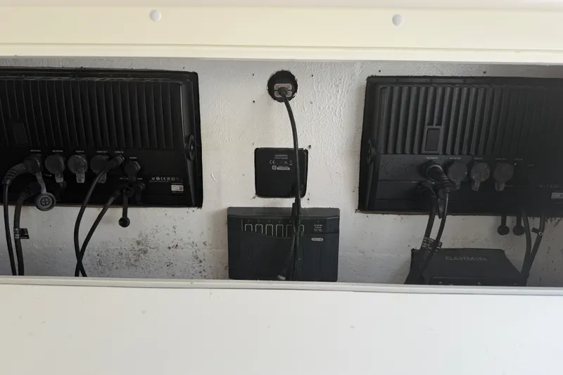 Slide: The Image of 2019 Invincible 36 Open Fisherman electronics panel with Garmin devices and wiring. - 51