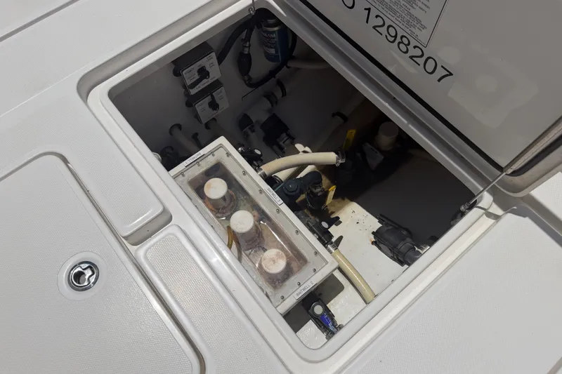 Slide: The Image of 2019 Invincible 36 Open Fisherman boat compartment with visible wiring and components. - 38