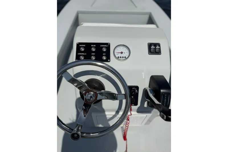 Slide: The Image of Steering console of 2024 Homeade 15 boat with controls and gauges. - 16
