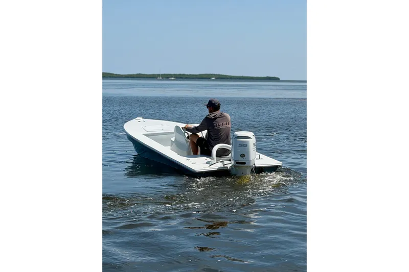 Slide: The Image of Man steering 2024 Homeade 15 boat on calm water. - 8