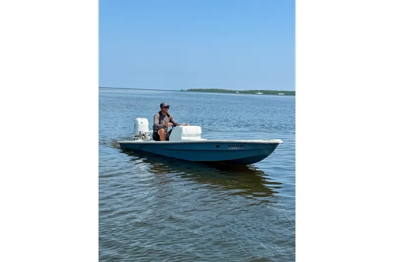 Slide: The Image of Man operating Homemade 15 boat on calm water, 2024 model. - 6