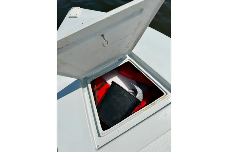 Slide: The Image of Open storage compartment on 2024 Homeade 15 boat, containing various items. - 18