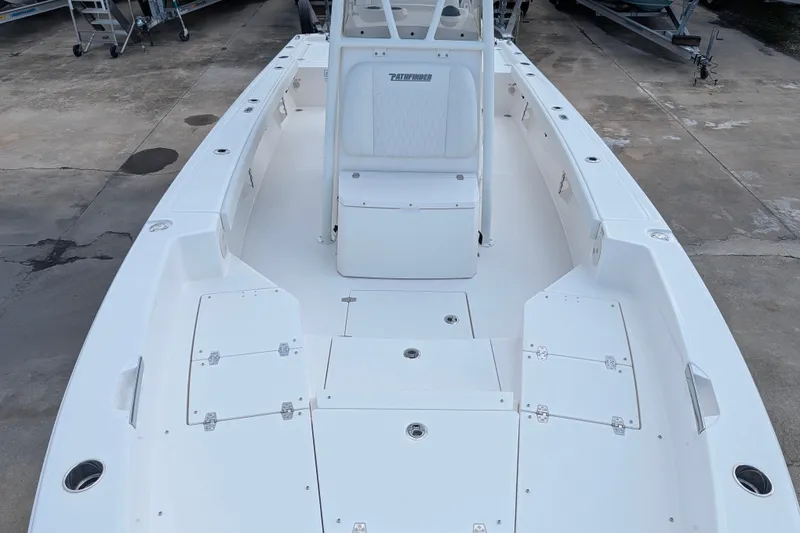 Slide: The Image of The image shows the deck of a white Pathfinder 2600 Hybrid boat with seating and storage. - 24