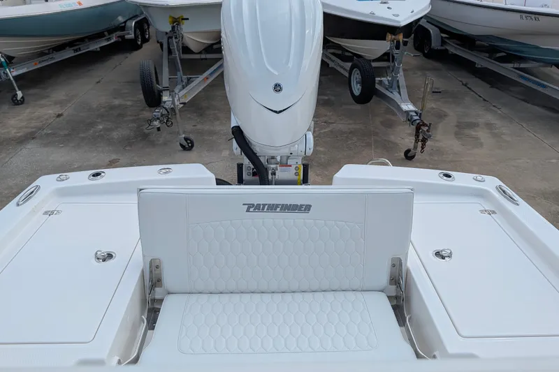 Slide: The Image of The image shows the stern of a Pathfinder 2600 Hybrid boat with an engine and cushioned seating. - 30