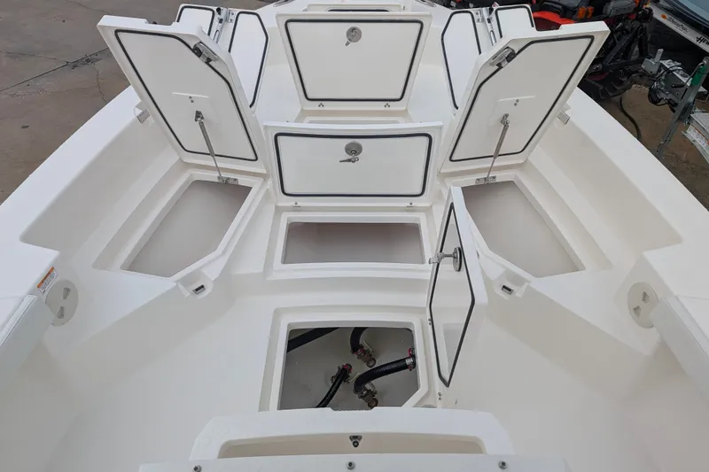 Slide: The Image of 2027 Pathfinder 2600 Hybrid boat storage compartments open, showcasing spacious interior design. - 27