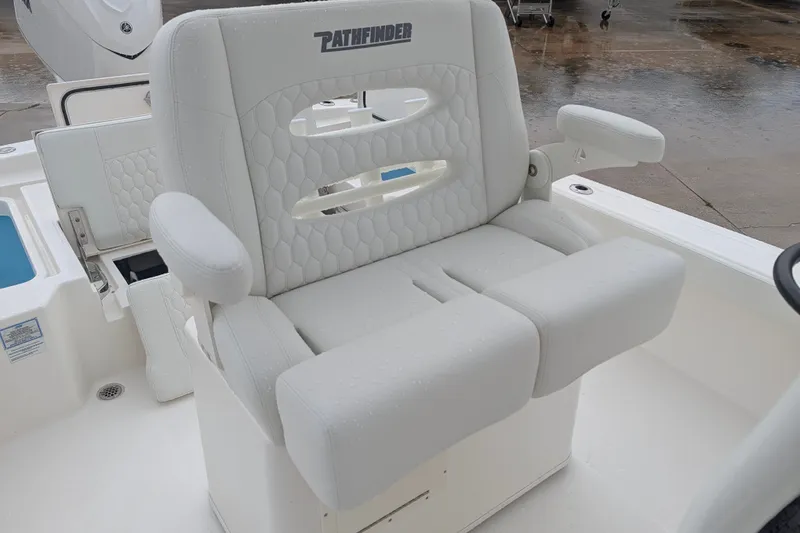 Slide: The Image of White cushioned seat on a 2027 Pathfinder 2600 Hybrid boat, featuring armrests and a sleek design. - 19