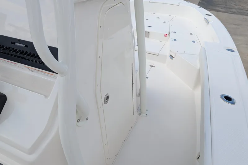 Slide: The Image of The image shows the deck of a Pathfinder 2600 Hybrid boat with white surfaces and storage space. - 15