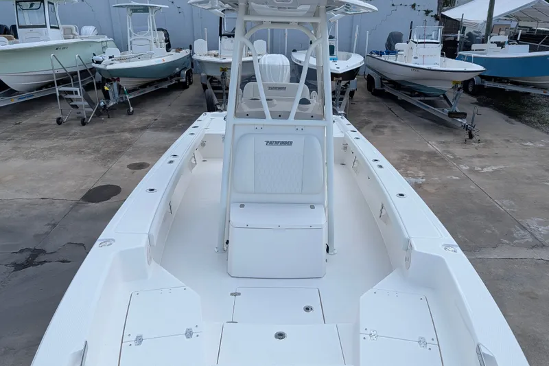 Slide: The Image of A modern 2027 Pathfinder 2600 Hybrid sits on a concrete lot, surrounded by other boats. - 25
