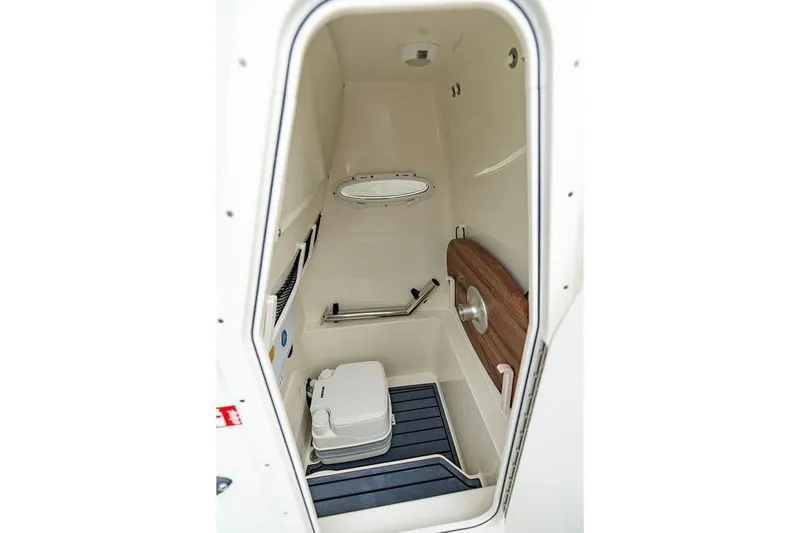 Slide: The Image of Manufacturer Provided Image: Interior of 2027 Pathfinder 2600 Hybrid boat, featuring compact marine toilet. - 17