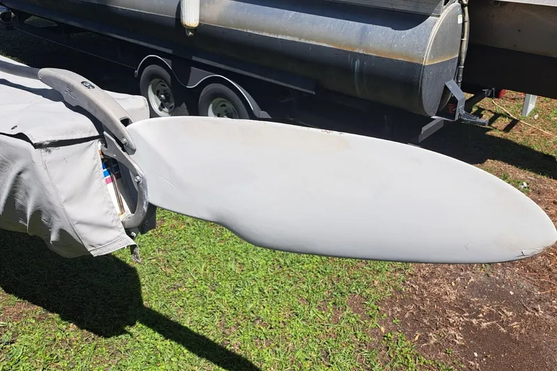Slide: The Image of Rudder of a 1989 Hobie Cat 21 sailboat, covered and resting on grass. - 5