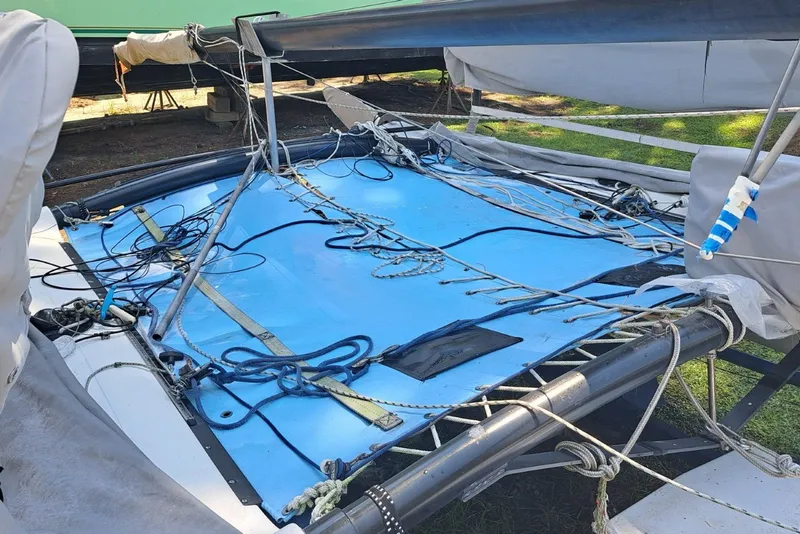 Slide: The Image of 1989 Hobie Cat 21 sailboat deck with rigging and blue trampoline. - 12