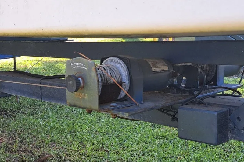 Slide: The Image of Trailer winch mechanism for 1989 Hobie Cat 21 sailboat on grassy surface. - 9