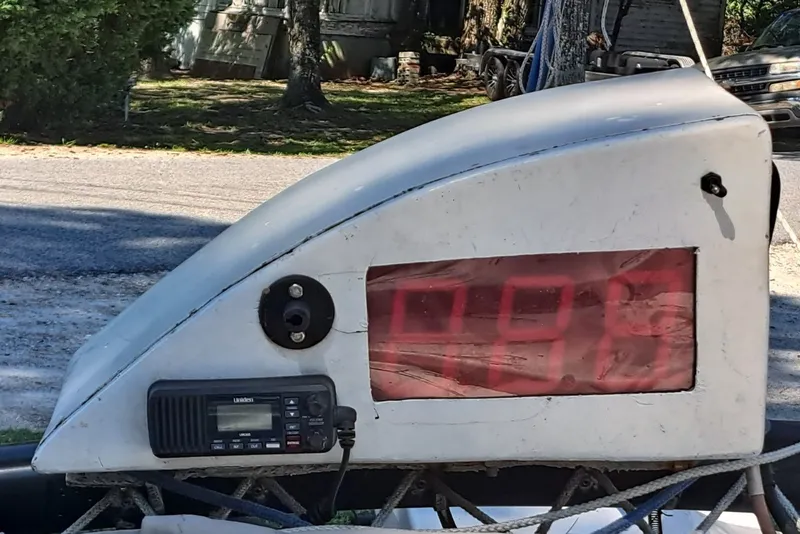 Slide: The Image of Close-up of a 1989 Hobie Cat 21 sailboat component with digital display and radio. - 11