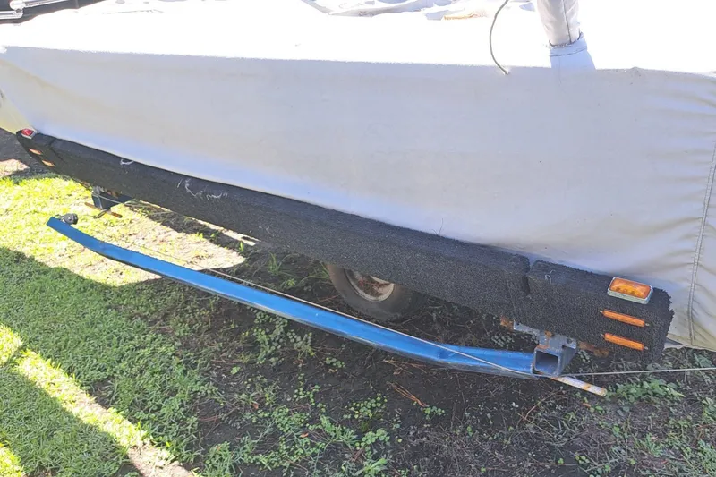 Slide: The Image of Covered 1989 Hobie Cat 21 sailboat on trailer, parked on grass. - 6