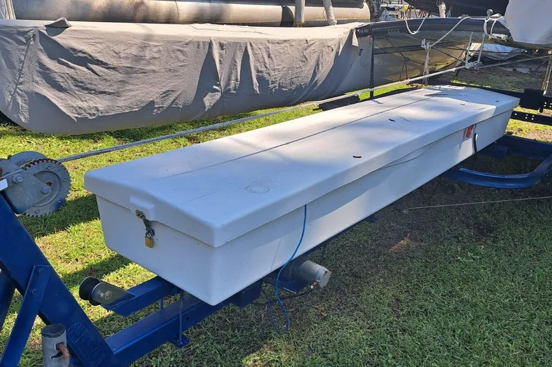 Slide: The Image of 1989 Hobie Cat 21 sailboat on trailer, featuring a white storage compartment. - 7