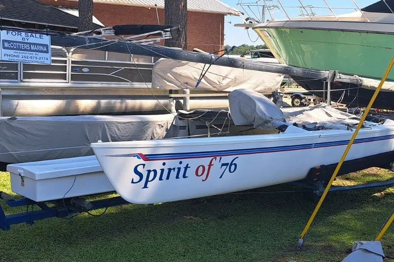 Slide: The Image of 1989 Hobie Cat 21 sailboat named "Spirit of '76" on trailer at marina. - 0