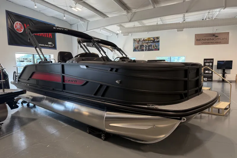 The Image of 2027 Evotti 521CS pontoon boat displayed in a showroom with Yamaha and Bennington banners. - 1