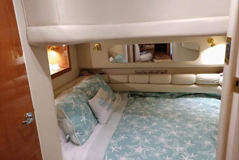 Slide: The Image of Cozy bedroom interior of 1999 Sea Ray Sundancer 400 yacht with starfish-themed bedding. - 9