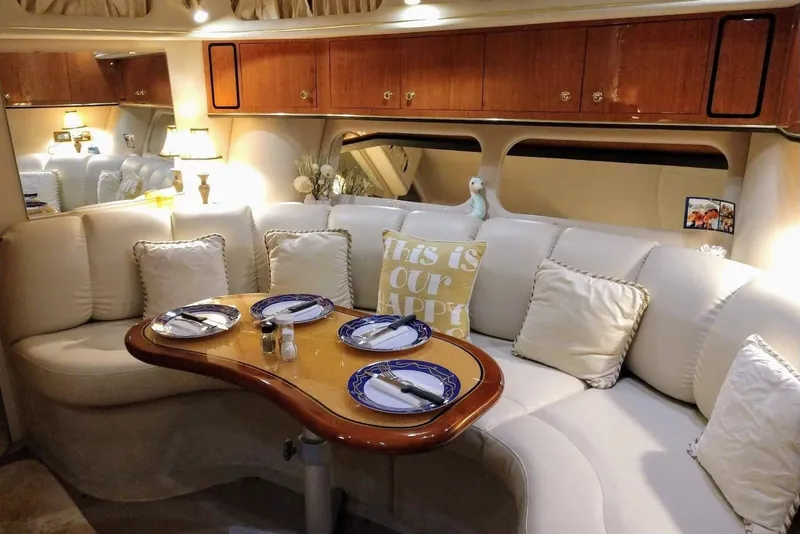 Slide: The Image of Luxurious 1999 Sea Ray Sundancer 400 interior with elegant dining area and plush seating. - 5