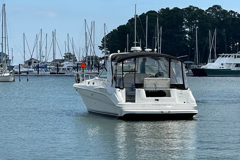 Slide: The Image of 1999 Sea Ray Sundancer 400 yacht docked in a marina with sailboats. - 2