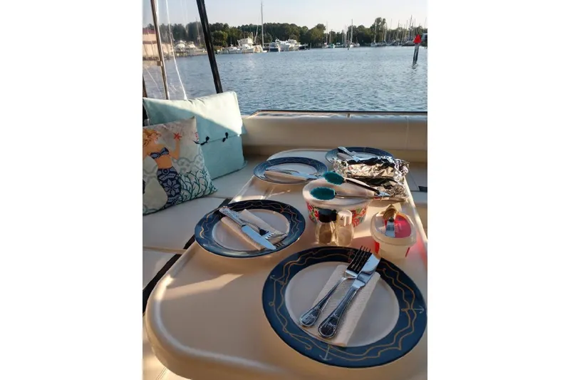 Slide: The Image of Dining setup on a 1999 Sea Ray Sundancer 400 yacht with waterfront view. - 3