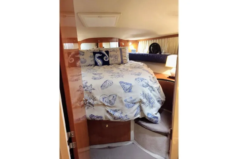 Slide: The Image of Cozy cabin interior of 1999 Sea Ray Sundancer 400 with nautical-themed bedding. - 7
