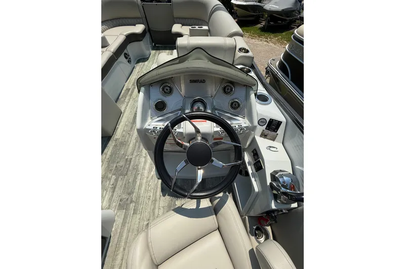 Slide: The Image of 2018 Crest Caribbean 250 SLS boat interior with steering wheel and control panel. - 10
